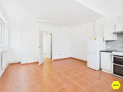 an empty kitchen with white appliances and a tile floor at New Spacious apartment in Milton