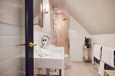 a bathroom with a sink and a toilet at The White Hart Inn in West Mersea
