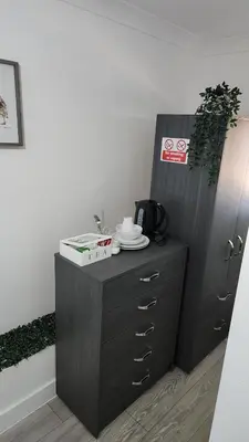 a wooden cabinet with a plate on top of it at Luxurious ensuite rooms in Basildon
