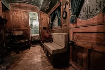 a train car with a chair in a room at Romantic 1920s Circus Wagon Experience in Sutton