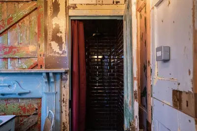 an empty room with a staircase in an old building at Romantic 1920s Circus Wagon Experience in Sutton