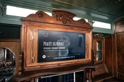 a large wooden tv with a man on it at Romantic 1920s Circus Wagon Experience in Sutton