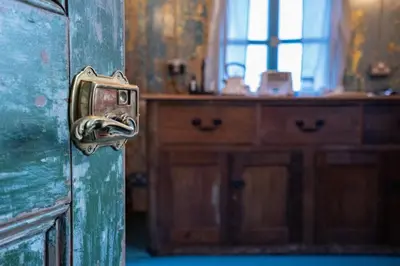 an old door with a latch in a room at Romantic 1920s Circus Wagon Experience in Sutton