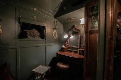 a bathroom with a sink and a mirror at Romantic 1920s Circus Wagon Experience in Sutton