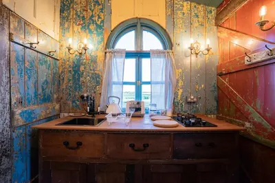 a kitchen with a sink and a window at Romantic 1920s Circus Wagon Experience in Sutton
