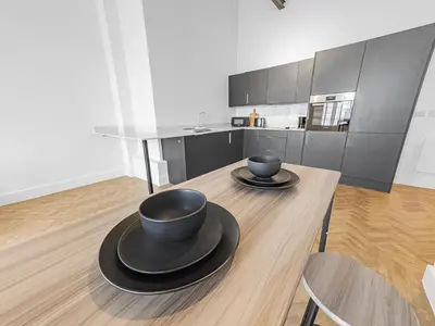 a kitchen with a wooden table with two bowls on it at Bright & Cozy in Chelmsford in Chelmsford