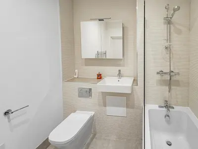 a bathroom with a toilet and a sink and a tub at Bright & Cozy in Chelmsford in Chelmsford