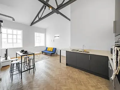 a kitchen and living room with a table and chairs at Bright & Cozy in Chelmsford in Chelmsford