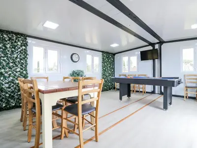 a dining room with a ping pong table and chairs at Luxury Shepherd Hut with Private Hot Tub in Swaffham Bulbeck