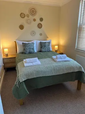 a bedroom with a bed with two towels on it at Ground floor 1 bed studio apartment Near station in Downham Market