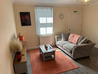 a living room with a couch and a table at Ground floor 1 bed studio apartment Near station in Downham Market
