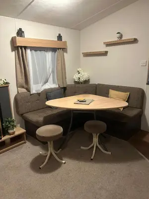 a living room with a couch and a table at 2 bed caravan seawick hoilday Park in Clacton-on-Sea