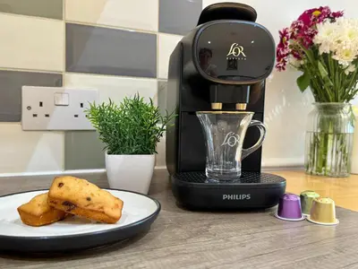 a coffee maker with a plate of food on a counter at 2 bed Elegant Flat in Stansted with parking in Stansted Mountfitchet