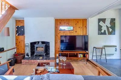 a living room with a couch and a fireplace at Finest Retreats - Hollybush Studio in Knebworth