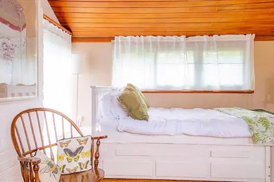 a bedroom with a white bed and a window at Finest Retreats - Hollybush Studio in Knebworth