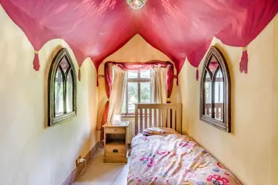 a bedroom with a bed and a pink ceiling at 2 Bed in Nayland oc-b32342 in Nayland