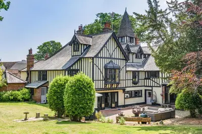 an exterior view of a large black and white house at 2 Bed in Nayland oc-b32342 in Nayland