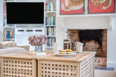 a coffee table in a living room with a fireplace at 4 Bed in Hartest oc-w32685 in Hartest