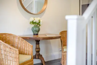 a vase of flowers on a table with two chairs at 4 Bed in Hartest oc-w32685 in Hartest