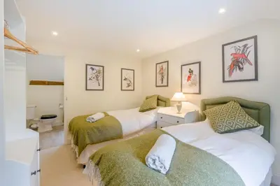 a bedroom with two beds and a bathroom at 4 Bed in Hartest oc-w32685 in Hartest