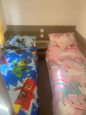 a bedroom with two beds with toys on them at Seawick Holiday Park in Saint Osyth