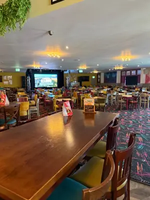 a dining room with a large wooden table and chairs at Seawick Holiday Park in Saint Osyth