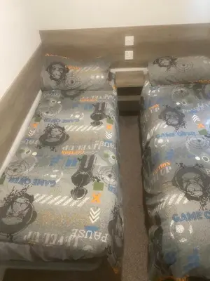 a bedroom with a bed with a bike themed bedspread at Seawick Holiday Park in Saint Osyth