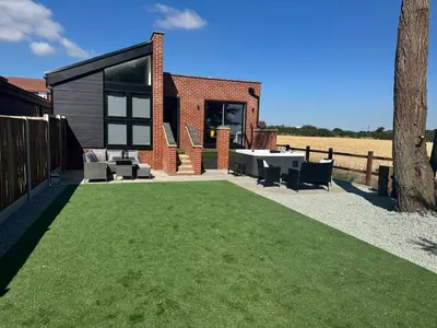 a backyard with a ping pong table and a lawn at Rural Retreats 8 in Southminster