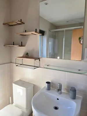 a bathroom with a toilet and a sink and a mirror at Spacious & Homely Colchester Stay-Great Location in Hythe