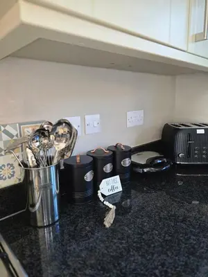 a kitchen counter with a bunch of utensils at Spacious & Homely Colchester Stay-Great Location in Hythe