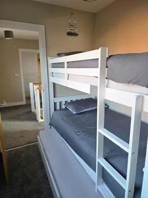 a couple of bunk beds in a room at Spacious & Homely Colchester Stay-Great Location in Hythe