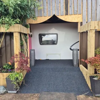 a garage with a door open with plants at The Cosy Hide - A romantic rural retreat for 2 in Cottenham