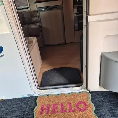 an open door of an rv with a kitchen at The Cosy Hide - A romantic rural retreat for 2 in Cottenham