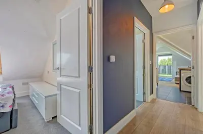 a room with an open door and a hallway at Penthouse with amazing view in Romford