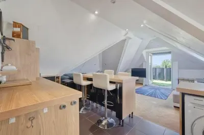 a kitchen with a table and chairs in a attic at Penthouse with amazing view in Romford