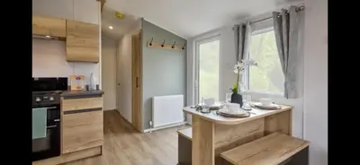 a kitchen with a table with dishes on it at Morsh Luxury Caravan Getaway in Colchester