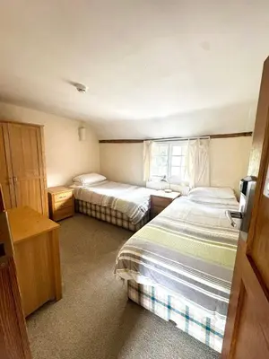 a hotel room with two beds and a window at Memorial University, Harlow Campus in Burnt Mill
