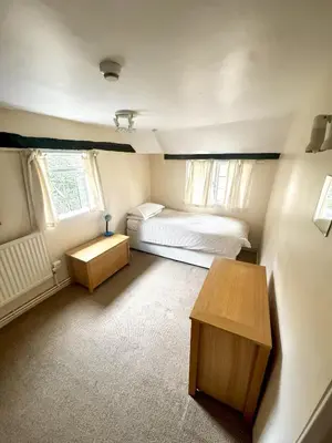 a small room with a bed and a table at Memorial University, Harlow Campus in Burnt Mill