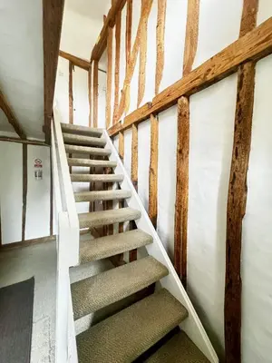 a staircase in a house with wooden beams at Memorial University, Harlow Campus in Burnt Mill