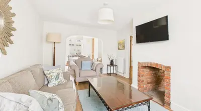 a living room with a couch and a fireplace at Courtyards, 9 Mount street,Diss in Diss