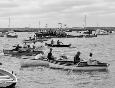 a group of people in boats in the water at Oyster Lodge in West Mersea