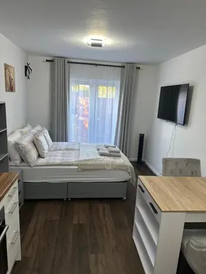 a bedroom with a bed and a television in it at Little side house in Cambridge in Trumpington