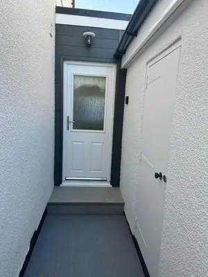 a white door with a window on a building at Little side house in Cambridge in Trumpington