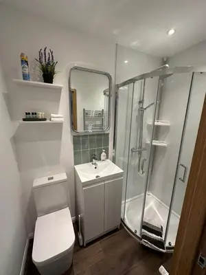 a bathroom with a shower and a toilet and a sink at Little side house in Cambridge in Trumpington