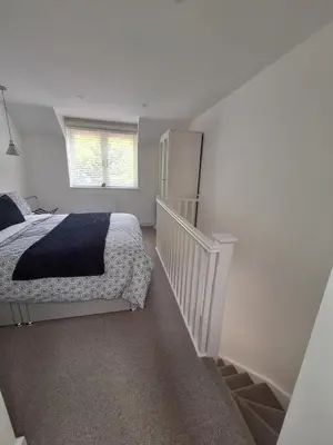 a white bedroom with a bed and a window at New Annexe in Gosfied in Gosfield