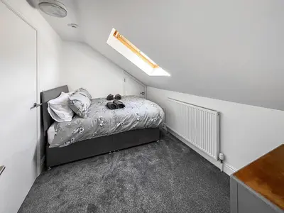 a small bedroom with a bed in a room at Moglett Cottage in Fincham