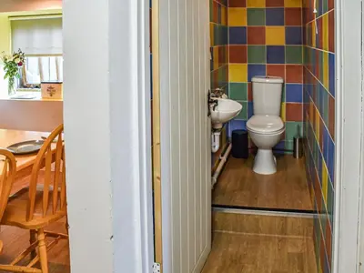 a bathroom with a toilet and a sink at The Pool House - Uk48229 in Tibenham