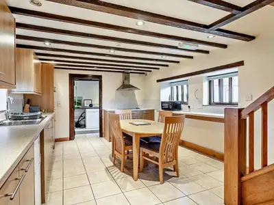 a kitchen and dining room with a table and chairs at Pond View Cottage - Uk48230 in Tibenham