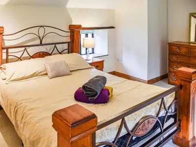 a bedroom with a bed with a hat on it at Pond View Cottage - Uk48230 in Tibenham