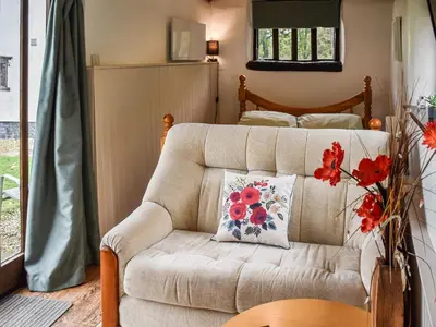 a living room with a couch and a bed at The Retreat - Uk48231 in Tibenham